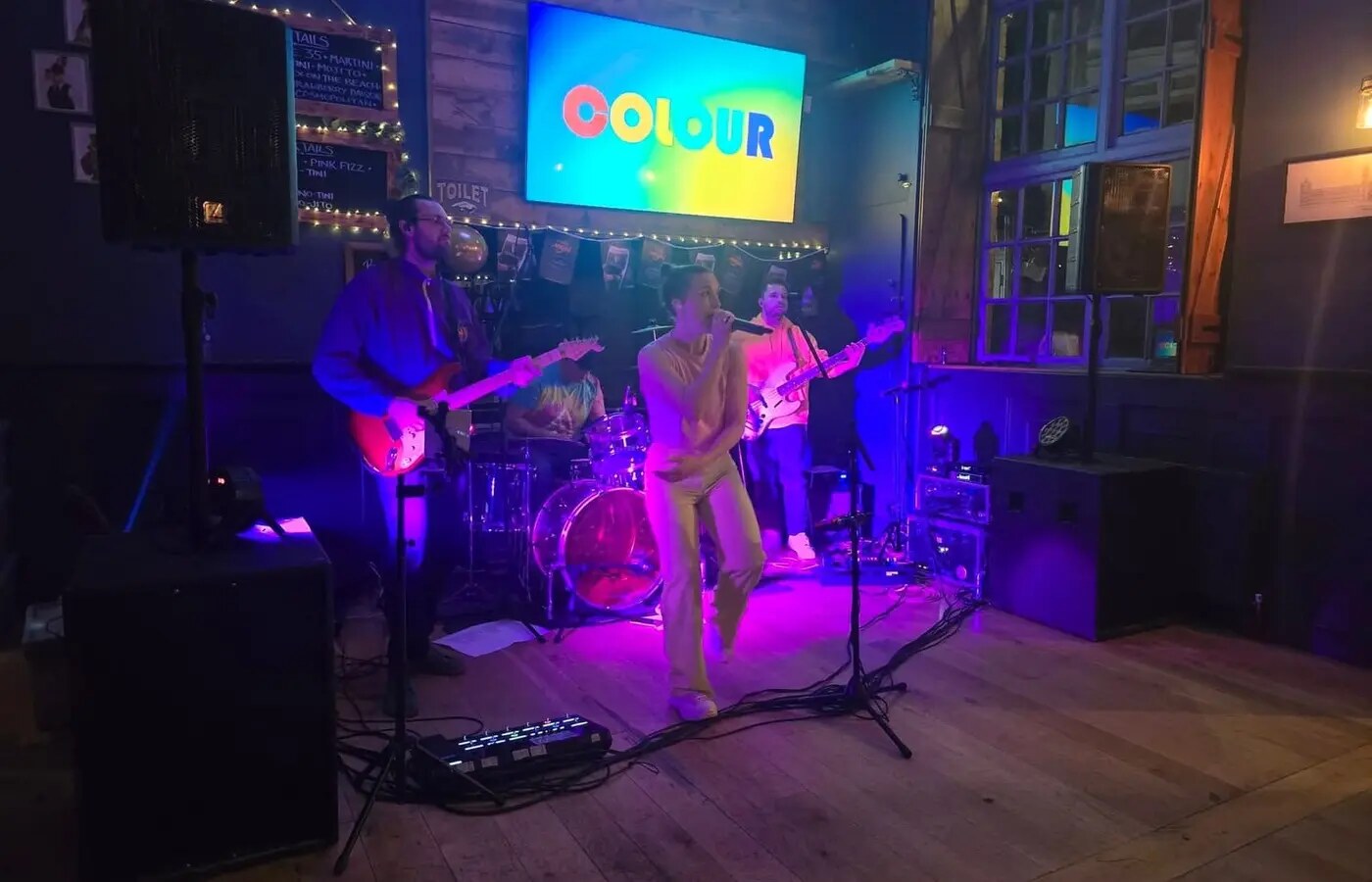 A live band performing on stage at Bar Thirty Five in Bude
