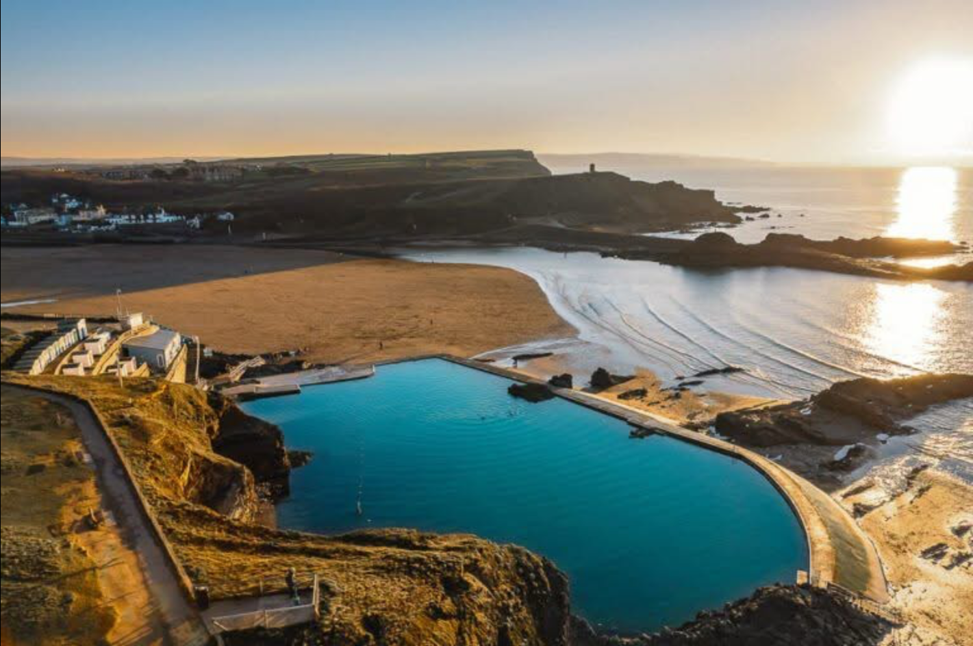 Golden-hour aerial view of Bude Sea Pool, Summerleaze Beach and the North Cornwall coast