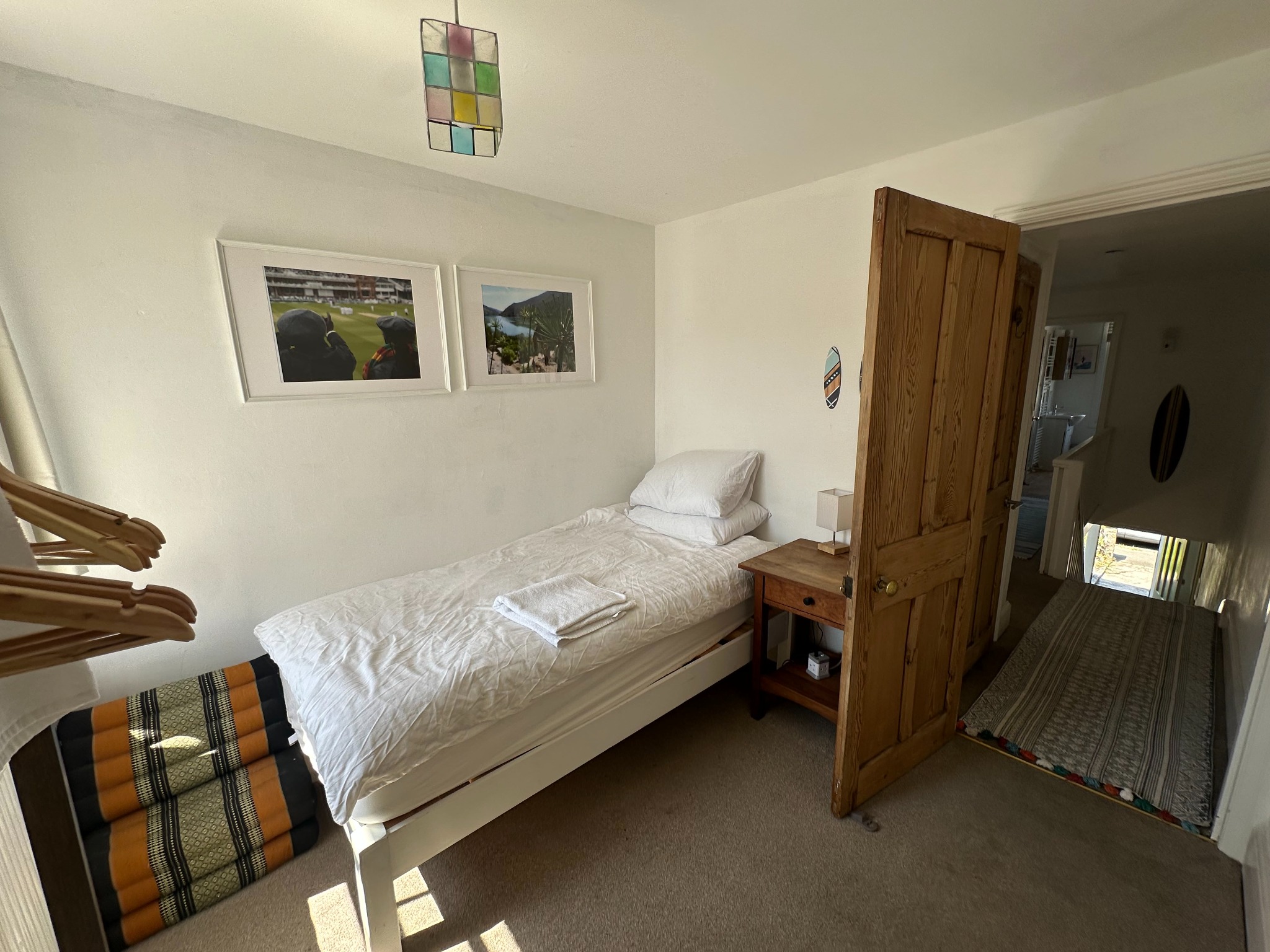 Single bedroom with fresh white linen at Bude Surf Shack