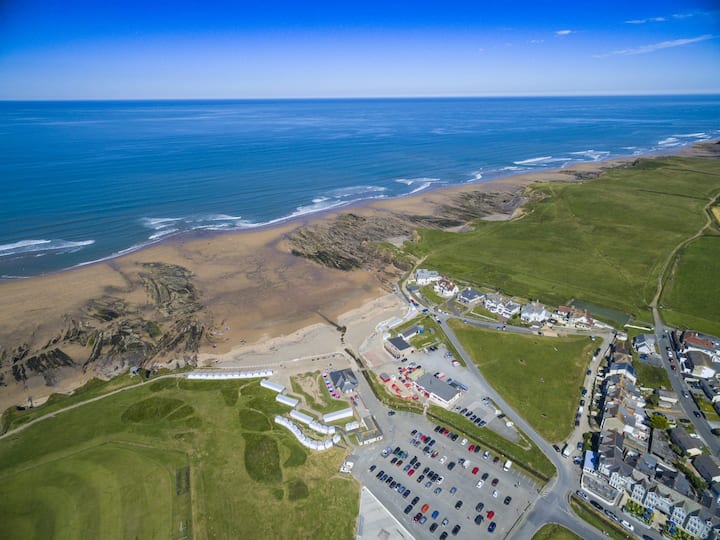 Aerial view of Crooklets Beach showing sand, reefs and surf gutters
