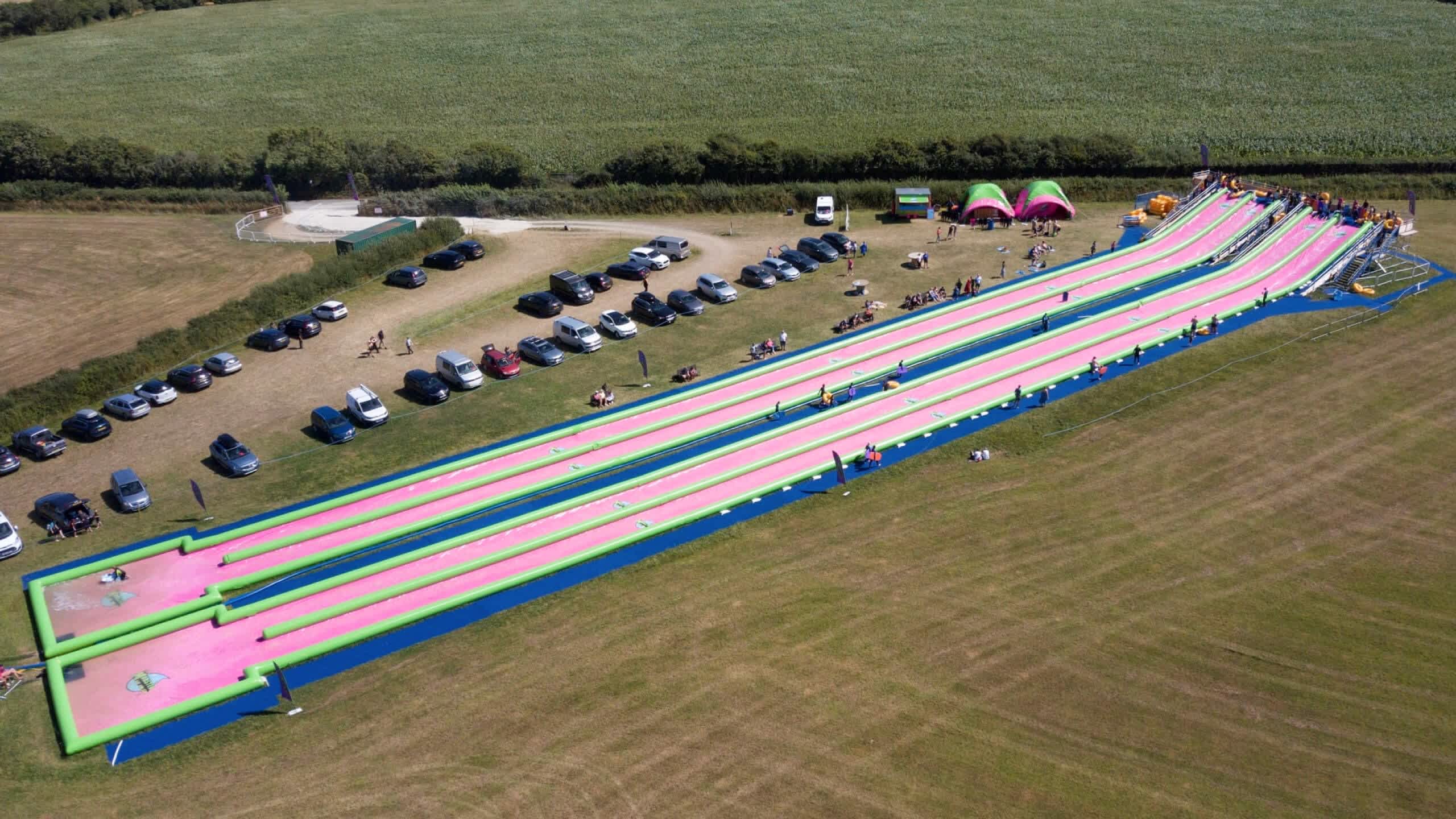 Children racing down the Monster Slip and Slide near Bude