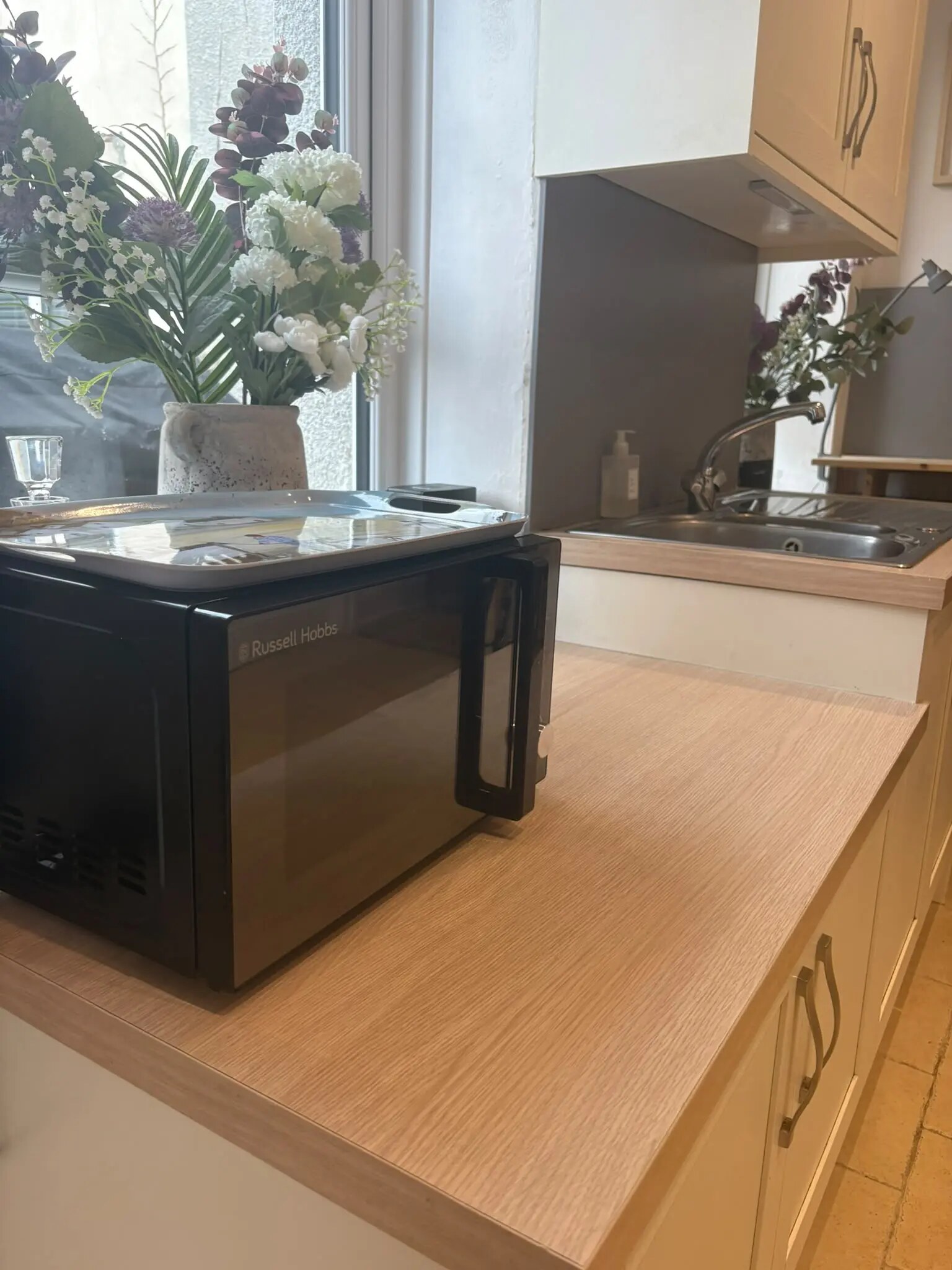Kitchen sink, breakfast bar and window at Bude Surf Shack