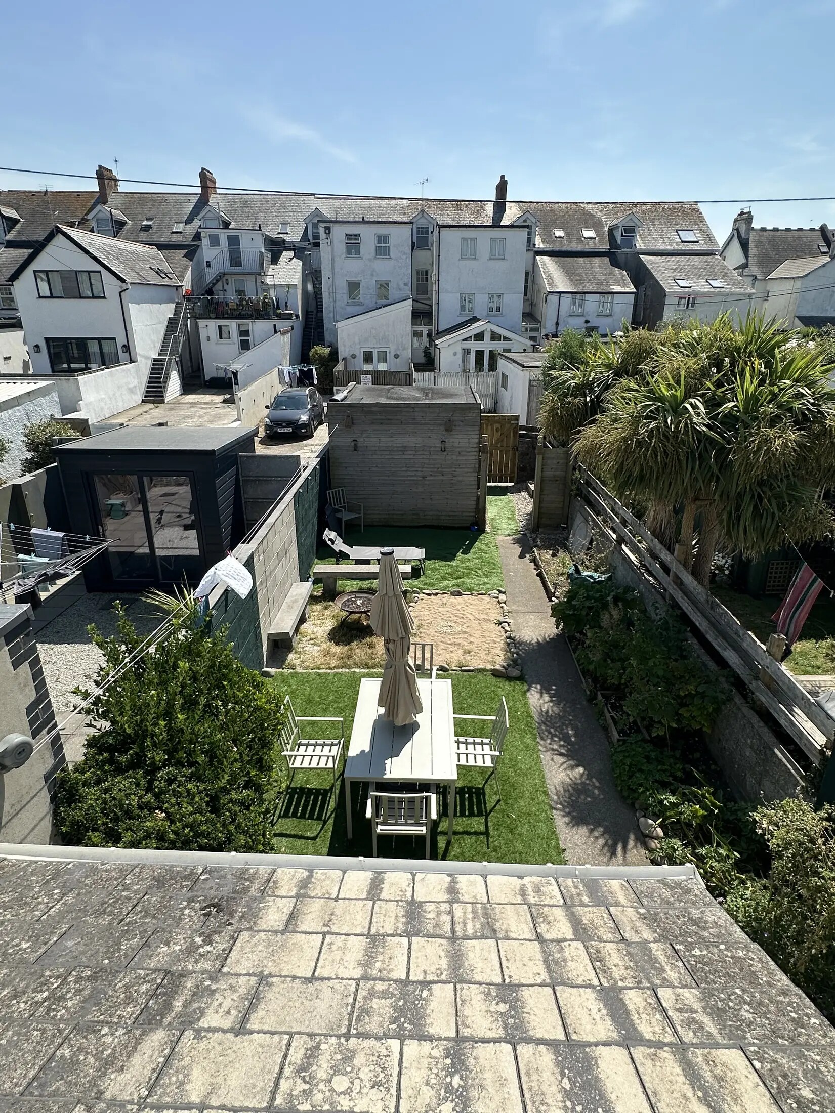 Rear garden with dining table and firepit at Bude Surf Shack